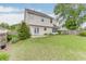 View of the back of the house, highlighting the well-maintained lawn, patio, and access via double doors at 5555 Sugar Crossing Dr, Sugar Hill, GA 30518
