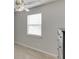 A bright bedroom with carpet flooring and a window at 5555 Sugar Crossing Dr, Sugar Hill, GA 30518