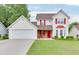Charming two-story home with well-manicured lawn, red shutters and matching front door at 5555 Sugar Crossing Dr, Sugar Hill, GA 30518