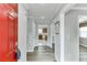 Hallway with gray walls and wood look floors, offers a glimpse into the well-lit kitchen at 5555 Sugar Crossing Dr, Sugar Hill, GA 30518