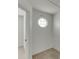 Bright hallway featuring carpet flooring and octagonal window at 5555 Sugar Crossing Dr, Sugar Hill, GA 30518