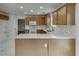 Updated kitchen with white countertops, white tile floor and stainless steel microwave at 5555 Sugar Crossing Dr, Sugar Hill, GA 30518