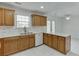 Charming kitchen boasts wooden cabinets, a bright white countertop, and matching backsplash at 5555 Sugar Crossing Dr, Sugar Hill, GA 30518