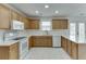 Bright kitchen with white appliances, and a decorative white backsplash at 5555 Sugar Crossing Dr, Sugar Hill, GA 30518