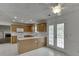 Updated kitchen with white countertops, white tile floor and stainless steel microwave, and eat in area at 5555 Sugar Crossing Dr, Sugar Hill, GA 30518