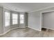 Living room with bay windows, offers a cozy and inviting space filled with natural light at 5555 Sugar Crossing Dr, Sugar Hill, GA 30518