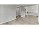 Spacious living room with neutral walls, seamlessly connects to the dining and kitchen areas at 5555 Sugar Crossing Dr, Sugar Hill, GA 30518