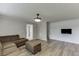 Inviting living room featuring modern flooring and a cozy seating area at 5555 Sugar Crossing Dr, Sugar Hill, GA 30518