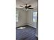 Bright bedroom with two windows, a ceiling fan, and stylish, new wood-look flooring at 725 S Fork Sw Dr, Marietta, GA 30008