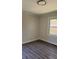 Bedroom featuring wood-look flooring and a window providing natural light at 725 S Fork Sw Dr, Marietta, GA 30008