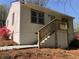 Charming home featuring a stair entrance, well-maintained siding, and blossoming landscaping at 725 S Fork Sw Dr, Marietta, GA 30008