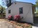 Quaint home exterior with beautiful blooming shrubs, fresh siding, and outdoor access stairs at 725 S Fork Sw Dr, Marietta, GA 30008
