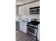 Stylish kitchen boasting stainless steel appliances, white cabinetry, and modern backsplash at 725 S Fork Sw Dr, Marietta, GA 30008