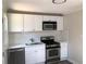 Updated kitchen featuring stainless steel appliances, white cabinets, and modern countertops at 725 S Fork Sw Dr, Marietta, GA 30008
