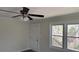 Bright living room featuring modern trim, large windows, a ceiling fan, and hardwood flooring at 725 S Fork Sw Dr, Marietta, GA 30008