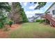 Expansive backyard with a lush green lawn, mature trees, and an inviting deck area at 116 Patrick Way, Marietta, GA 30064