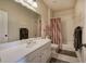 Bathroom with large mirror, shower-tub combo, neutral tile, and large vanity with chrome faucet at 116 Patrick Way, Marietta, GA 30064
