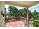 Covered deck providing views of lush greenery, featuring a table and chairs for relaxing and entertaining outdoors at 116 Patrick Way, Marietta, GA 30064