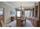 Elegant dining room with decorative window treatments, classic chandelier, and built-in cabinets at 116 Patrick Way, Marietta, GA 30064