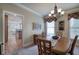 Traditional dining room with hardwood table, neutral paint, and elegant chandelier lighting at 116 Patrick Way, Marietta, GA 30064