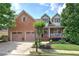 Charming brick home featuring a two-car garage and well-maintained landscaping at 116 Patrick Way, Marietta, GA 30064