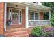 Inviting front porch with brick steps, white railing, and tasteful landscaping at 116 Patrick Way, Marietta, GA 30064