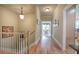 Upstairs hallway boasts hardwood floors and natural light streaming through the adjacent sitting room windows at 116 Patrick Way, Marietta, GA 30064