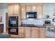 Kitchen with stainless steel appliances, ample cabinet space, and granite countertops adjacent to the living room at 116 Patrick Way, Marietta, GA 30064