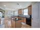 Bright kitchen features a central island with dark countertops, wood cabinets, and hardwood floors at 116 Patrick Way, Marietta, GA 30064