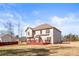 Backyard with a two story home, a red deck and lots of grass at 12348 Hillcrest Dr, Hampton, GA 30228