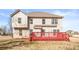 Backyard with a two story home, red deck and green grass at 12348 Hillcrest Dr, Hampton, GA 30228