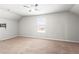 Spacious, neutral-toned bonus room with carpet flooring, window, and pre-installed TV mount at 12348 Hillcrest Dr, Hampton, GA 30228