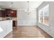 Bright dining area with wood floors, wainscoting, and a chandelier for warm, inviting meals at 12348 Hillcrest Dr, Hampton, GA 30228