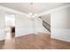 Dining area with hardwood floors, natural light, elegant wainscoting, and staircase at 12348 Hillcrest Dr, Hampton, GA 30228