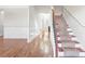 Inviting foyer with hardwood floors, staircase, and classic white wainscoting at 12348 Hillcrest Dr, Hampton, GA 30228