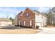 Home exterior showcasing brick and siding, a well manicured lawn, and an attached garage at 12348 Hillcrest Dr, Hampton, GA 30228