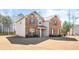 Two story house with brick and siding with a well manicured lawn at 12348 Hillcrest Dr, Hampton, GA 30228