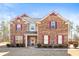Charming two-story brick home with a well-maintained lawn and complementary trim at 12348 Hillcrest Dr, Hampton, GA 30228