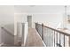 Second story hallway showing railing and view to stairs and lighting at 12348 Hillcrest Dr, Hampton, GA 30228