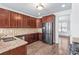 Well-equipped kitchen with stainless steel appliances, wood cabinets, and granite countertops at 12348 Hillcrest Dr, Hampton, GA 30228