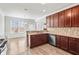 Modern kitchen featuring wood cabinets, stainless steel appliances, granite counters, and breakfast bar seating at 12348 Hillcrest Dr, Hampton, GA 30228