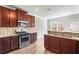 Open kitchen with stainless steel appliances, granite countertops, and mosaic tile backsplash at 12348 Hillcrest Dr, Hampton, GA 30228