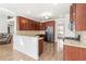 Well-equipped kitchen with stainless steel appliances, wood cabinets, granite countertops, and seating area at 12348 Hillcrest Dr, Hampton, GA 30228
