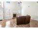 Bright living room with fireplace, wood floors, and soaring ceiling at 12348 Hillcrest Dr, Hampton, GA 30228