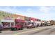 Charming street view showcasing local businesses with colorful storefronts and street parking at 12348 Hillcrest Dr, Hampton, GA 30228