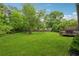Large backyard featuring a play area and a deck with a grill, perfect for outdoor activities at 1280 Gin House Ln, Lawrenceville, GA 30045