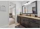 This bathroom features dark cabinets with granite countertops and a view to the sitting room at 1280 Gin House Ln, Lawrenceville, GA 30045