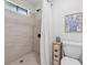 Clean bathroom features tiled walls and floors, a shower stall, a toilet, and a storage cabinet at 1280 Gin House Ln, Lawrenceville, GA 30045