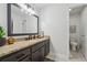 Tastefully updated bathroom featuring granite countertops, dark cabinetry, and a decorative mirror at 1280 Gin House Ln, Lawrenceville, GA 30045