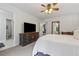 This bright bedroom includes an ensuite bathroom, and contains light walls and carpet at 1280 Gin House Ln, Lawrenceville, GA 30045